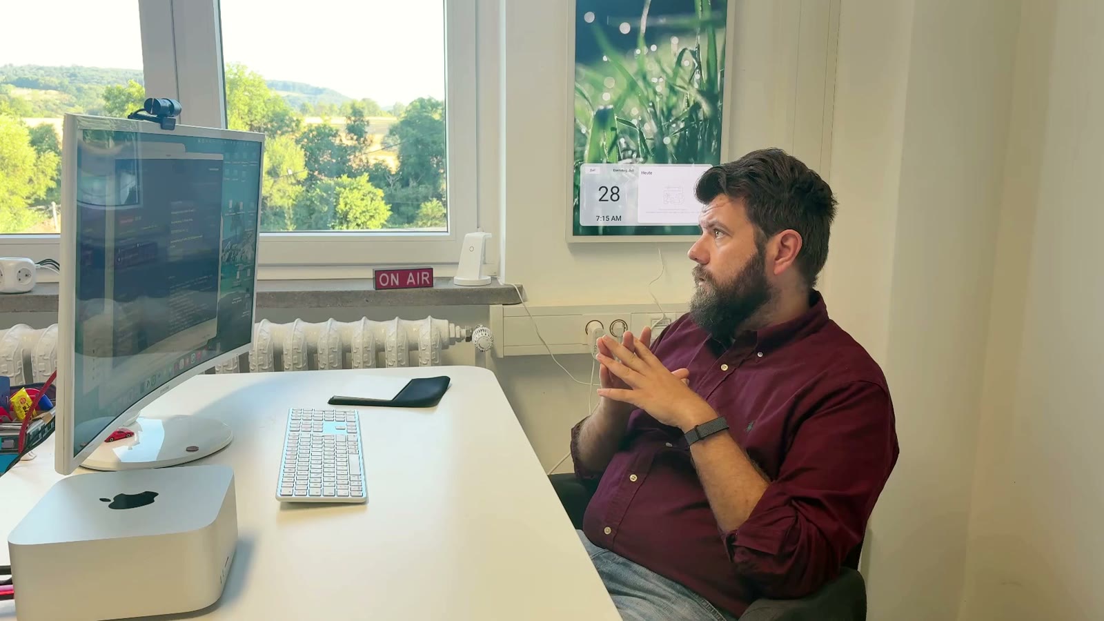 Philip arbeitet an seinem Mac am Schreibtisch